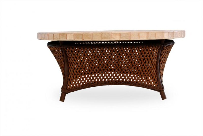 An elegant brown wicker coffee table with a light beige marble top, isolated on a white background. The table has a curved design with a textured, open-weave pattern on its base and includes an