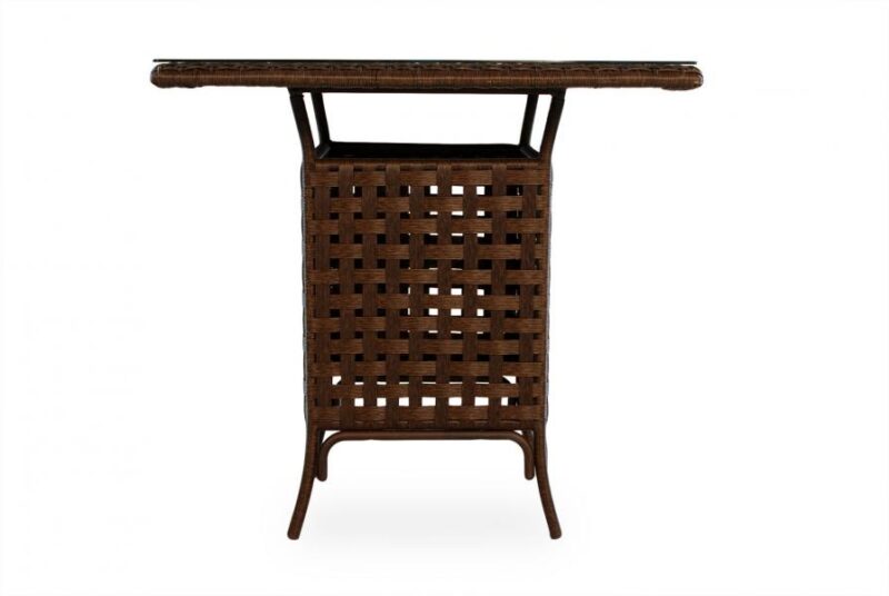 A dark brown rattan folding table with a woven top and crossed leg design, viewed against a white background with a fireplace insert.