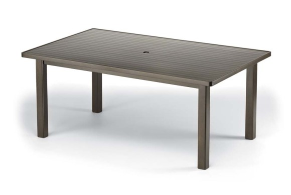 A simple rectangular outdoor table with a slatted top and a solid grey finish, shown in front of a plain fireplace.