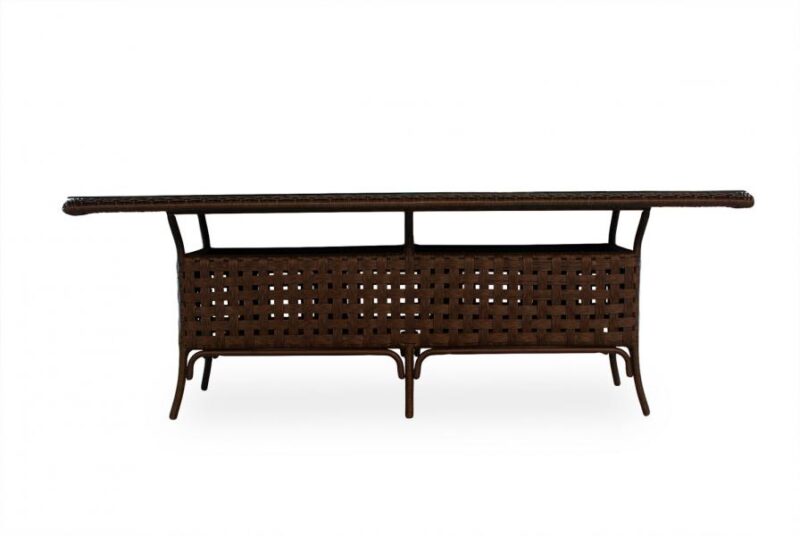 A contemporary, elongated wicker coffee table with a dark brown finish and sleek metal legs, featuring a built-in fireplace, isolated on a white background.