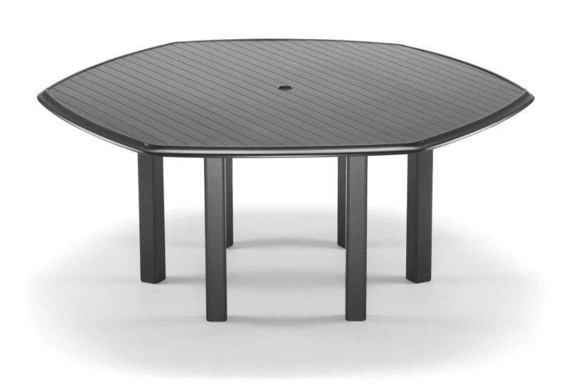 A modern, round, grey table with ribbed surface and four sturdy legs, isolated on a white background, featuring a built-in stove insert.