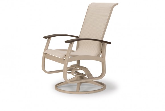 A beige outdoor swivel rocking chair with a metal frame and armrests, positioned near a fire pit on a plain white background.