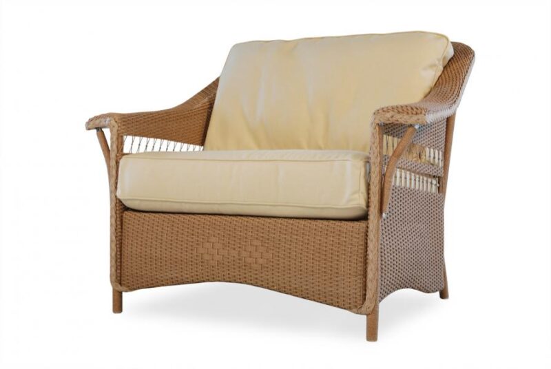 A wicker loveseat with beige cushions on a white background. The loveseat features a woven design and curved armrests, providing a comfortable seating option near the fire pit.