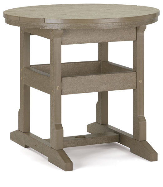 A round, wooden side table with a distressed finish, featuring two lower shelves and sturdy, interconnected leg supports. The table is displayed in a studio setting with a fireplace insert in the background.