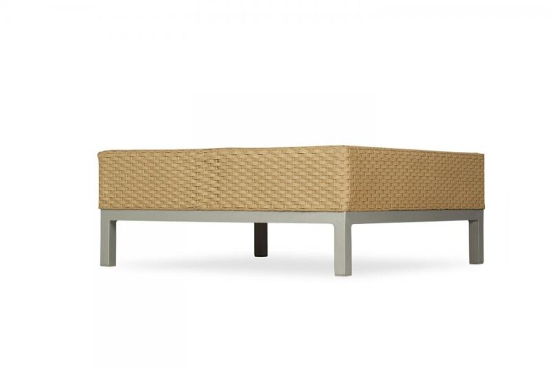 Beige, woven outdoor sofa with a modern design, featuring a textured body on a sturdy, grey metal frame with a fireplace insert, isolated against a plain white background.