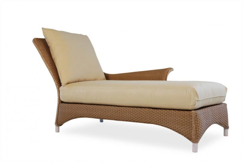 A modern chaise lounge with a woven brown base and cream cushions against a white background with a fireplace insert.