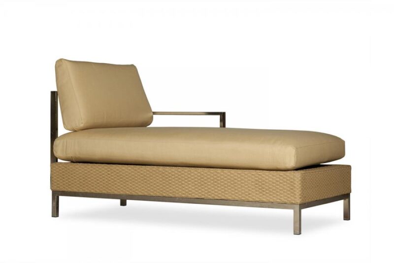 A modern beige chaise lounge with a large cushion and a mesh-like textured base, set against a plain white background, features an insert for a stove.