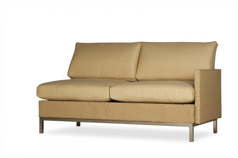 A modern beige outdoor sofa with thick cushions and a brown woven base, isolated on a white background, designed to beautifully complement your fire pit.