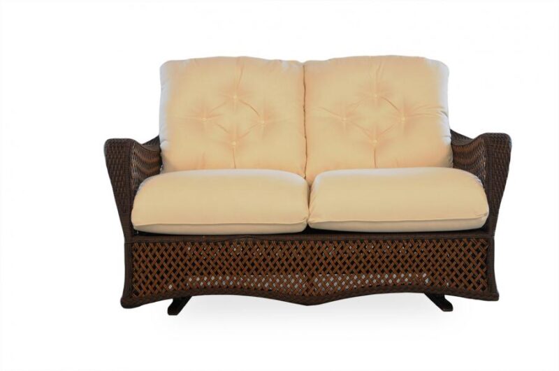 A two-seater wicker loveseat with plush beige cushions, featuring a tufted backrest and a lattice pattern on the base, isolated on a white background. This loveseat includes an insert