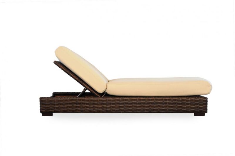 A modern wicker chaise lounge with a reclining back and cream cushions, isolated on a white background, featuring a fireplace insert.