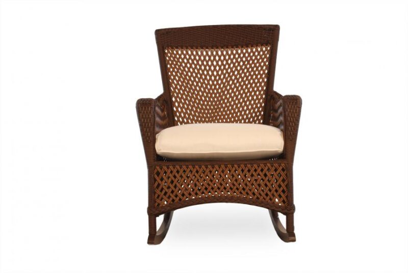 A dark brown wicker armchair with a light beige cushion on a white background. The chair features a high back, an intricate woven pattern, and is perfect beside a fire pit.