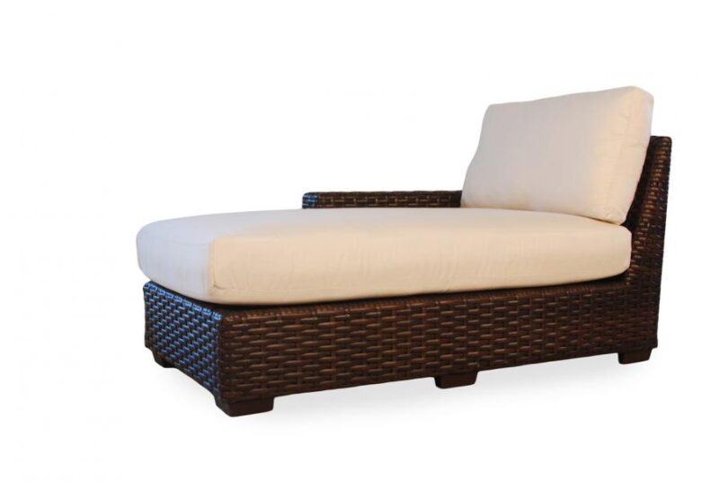 Single brown wicker chaise lounge with white cushions and a fireplace insert isolated on a white background.
