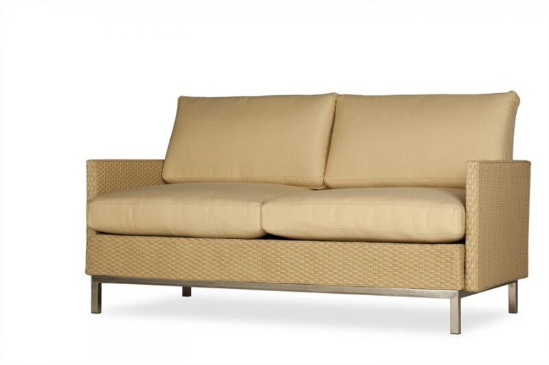 A modern beige sofa with two cushions, inserted near a fireplace, features a textured woven frame on a plain white background.
