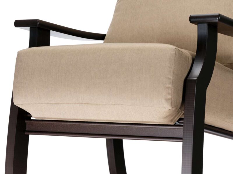 Close-up of a modern armchair with a beige cushion and sleek black wooden frame, isolated on a white background, suitable for insertion near a fire pit.