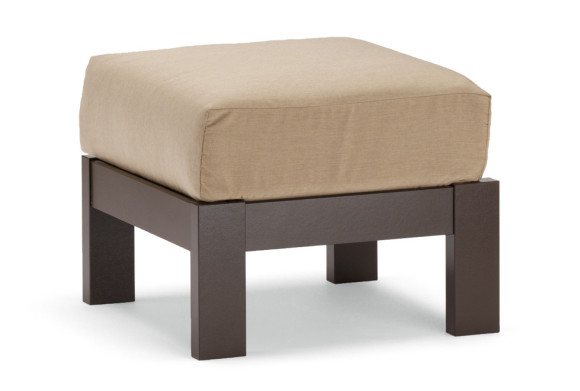 A modern square ottoman featuring a beige cushion on top of a dark brown wooden base with a fireplace insert, isolated on a white background.