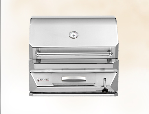 A stainless steel outdoor gas grill with a closed lid, featuring a temperature gauge on the top and a side handle, set against a plain light background.
