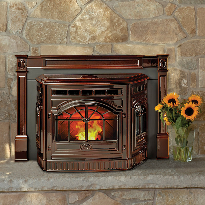 Castile pellet insert by Quadra-Fire in Porcelain Mahogany with a tan stone masonry and hearth