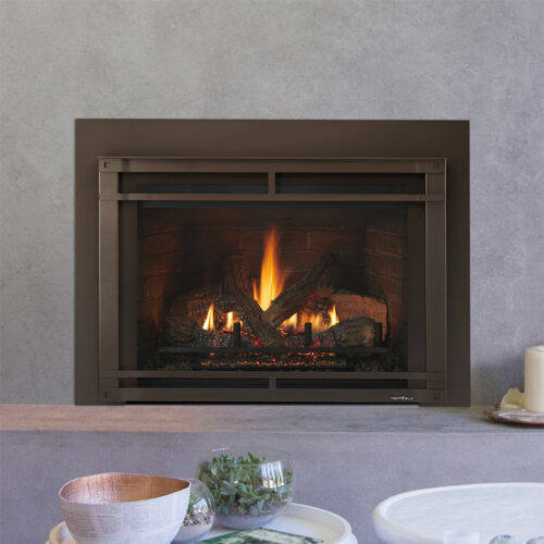 Escape gas fireplace insert by Heat & Glo in new bronze with Halston front against a gray concrete hearth