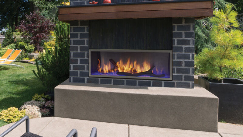 Lanai outdoor gas fireplace by Outdoor Lifestyles with wood kit and dark gray brick hearth in modern patio