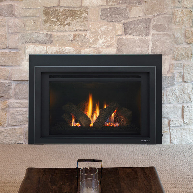 Providence Series gas fireplace insert by Heat & Glo in black against a tan stone masonry hearth