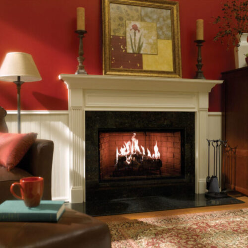 Royal Hearth wood fireplace by Heat & Glo in Black with Bi-Fold Glass doors with a black surround in a living room