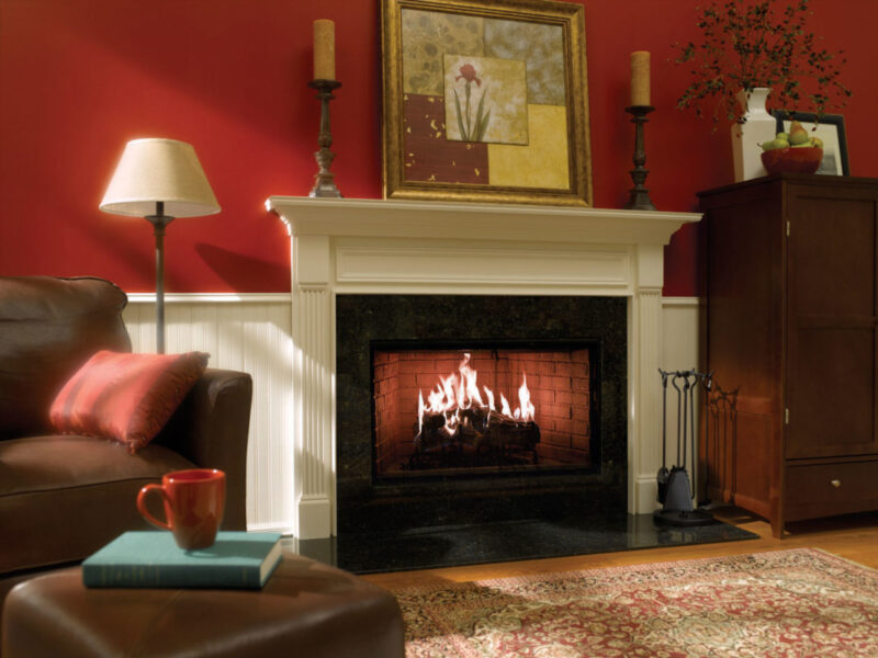 Royal Hearth wood fireplace by Heat & Glo in Black with Bi-Fold Glass doors with a black surround in a living room