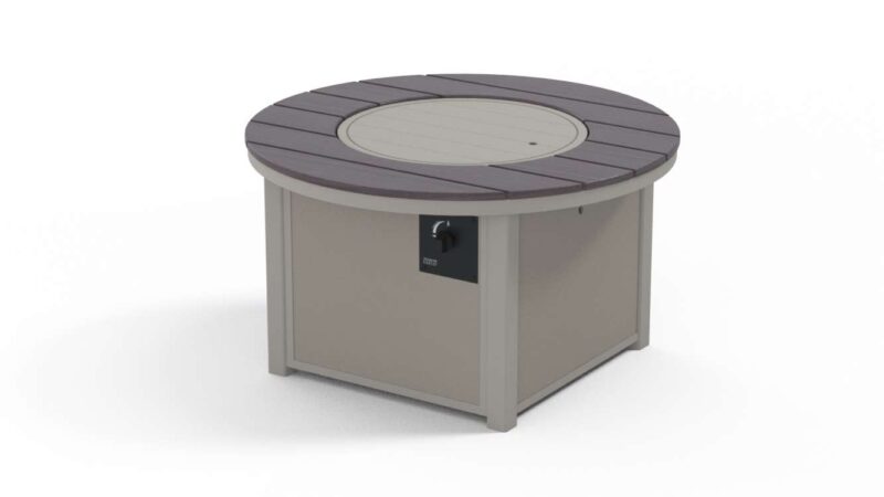 A modern, circular outdoor fire pit table with a beige base, a combination of grey and darker grey wooden slats on the surface, and a small black control panel with a knob on the side.