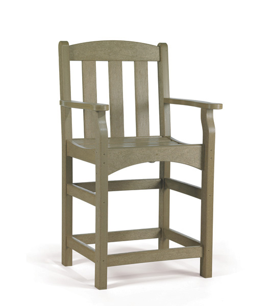 A high-backed, green adirondack chair made of plastic, featuring broad armrests and a sturdy frame, set beside a fireplace against a plain white background.