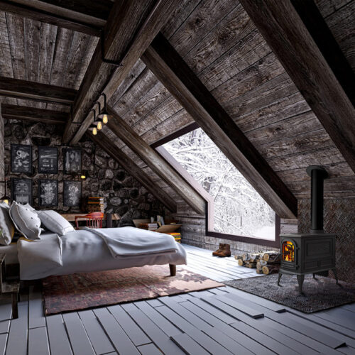Cozy attic bedroom featuring a wood-burning stove, a large bed with white linens, rustic wooden beams, and a window showcasing a snowy landscape.