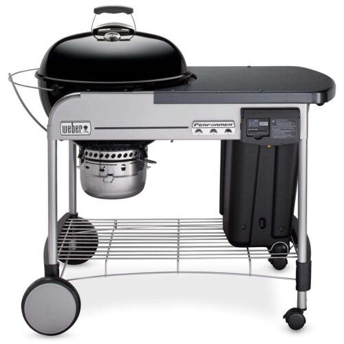 Weber Performer Charcoal Grill with a black kettle, attached side table, lower rack, and wheels, showcasing a built-in timer and tool hooks.