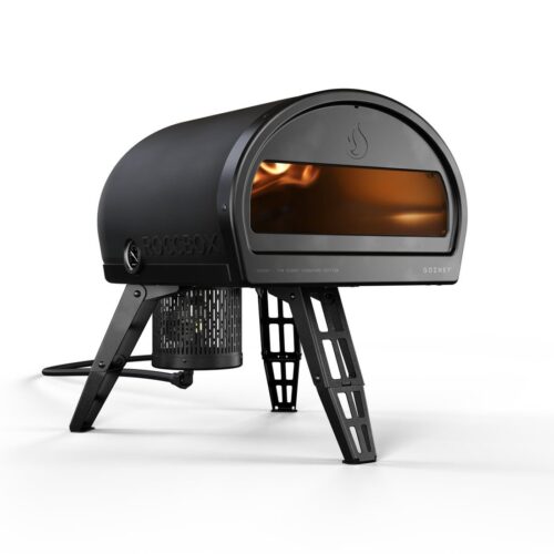 A black, modern Tom Gozney Signature Edition Roccbox pizza oven with visible internal flames, standing on a four-legged metal base, isolated on a white background.