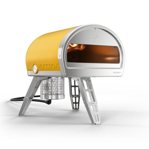 A Limited Edition Yellow Roccbox pizza oven by Gozney, featuring a metal housing and sturdy foldable legs, isolated on a white background.