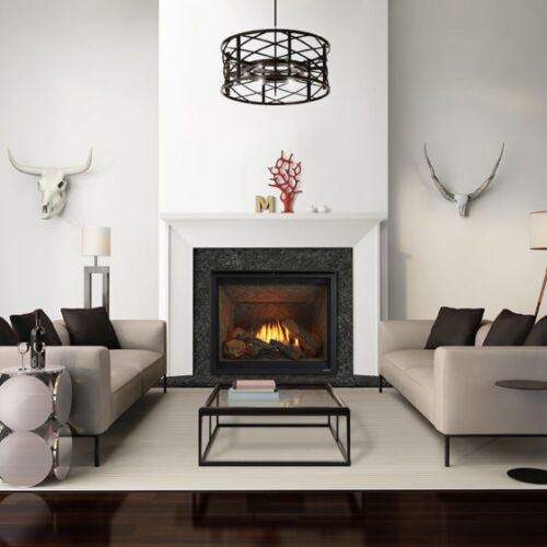 Modern living room with two cream sofas, a sleek coffee table, and a Heat & Glo 6K/8K Series Gas Fireplace. Decor includes a chandelier, wall-mounted animal skulls, and