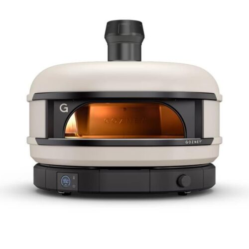A modern, portable pizza oven with a sleek design, featuring a front glass door and a visible flame inside, set against a plain white background.