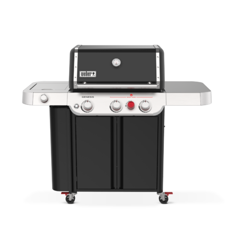 A weber genesis gas grill with stainless steel burners, a black hood, cooking grids, and a side burner on a cart with wheels, against a plain background.