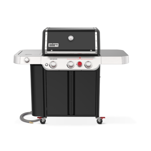 A weber genesis gas grill with three burners, control panel in front, and a closed black storage cabinet underneath. it has side metal shelves and a propane tank hose visible.