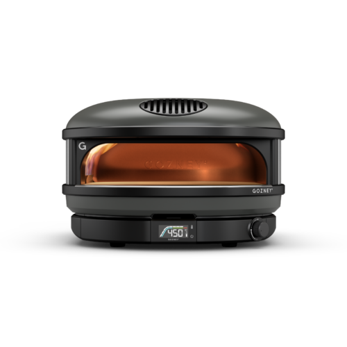 A modern, portable gozney pizza oven with a digital temperature display, glowing interior, and a sleek black design.